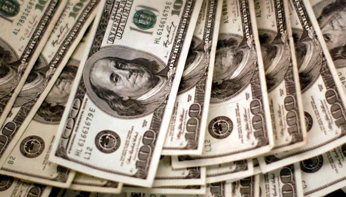 Four thousand U.S. dollars are counted out by a banker counting currency at a bank in Westminster, Colorado November 3, 2009. — Reuters