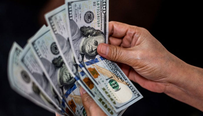 A person shows US dollars at a currency exchange store in Manila, Philippines, October 21, 2022. — Reuters