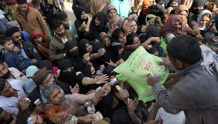 People gather around a truck to buy subsidised flour bags. — Twitter