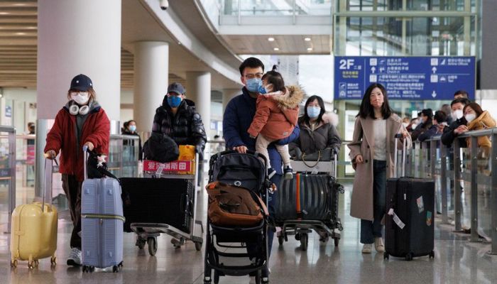 Passengers push their luggage through the international arrivals hall at Beijing Capital International Airport after China lifted the coronavirus disease (COVID-19) quarantine requirement for inbound travellers in Beijing, China January 8, 2023.— Reuters