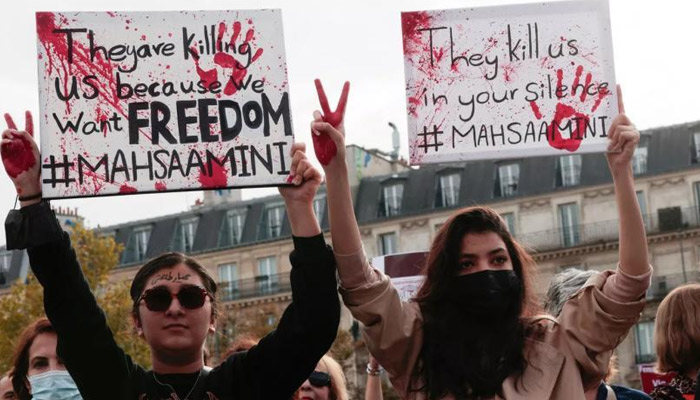 Women hold up placards in support of Mahsa Amini, whose execution by Iran has sparked protests across the country and the world. — AFP/Files