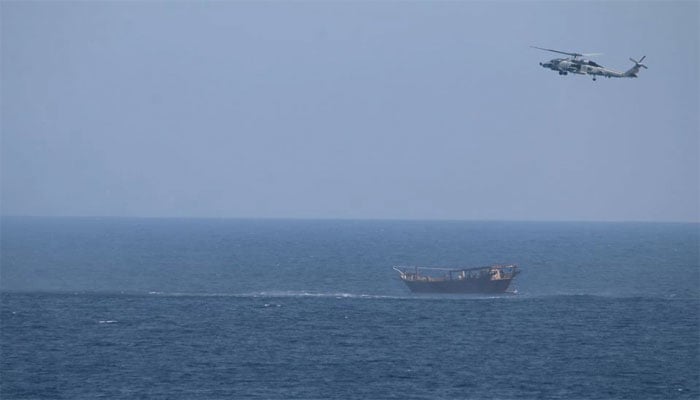 An SH-60 Seahawk helicopter assigned to the US guided-missile cruiser USS Monterey (CG 61)(not shown) flies above a stateless dhow interdicted with a shipment of illicit weapons in international waters of the North Arabian Sea. — Reuters/File