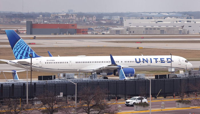 A plane of the United Airlines waits at the OHare International Airport, Chicago, Illinois on December 13, 2022. — AFP