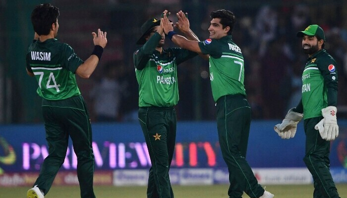 Naseem Shah celebrates with teammates after taking a wicket during the first ODI match between Pakistan and New Zealand at the National Stadium in Karachi on January 9 2023. — AFP