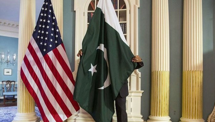 A State Department contractor adjusts a Pakistan national flag at the State Department in Washington. — Reuters/File