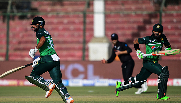 Pakistans Fakhar Zaman (left) and teammate Mohammad Rizwan (right) run between the wickets during the third and final one-day international (ODI) cricket match between Pakistan and New Zealand at the National Stadium in Karachi on January 13, 2023. — AFP