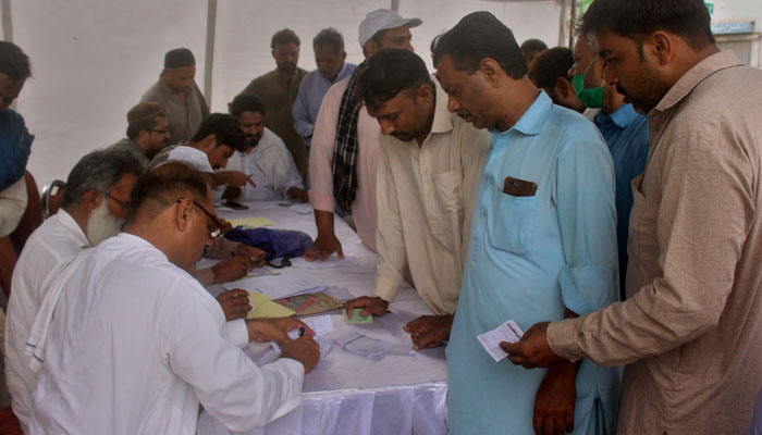 Voters searching theirs name from voter list during by-election at constituency PP217. — APP/File