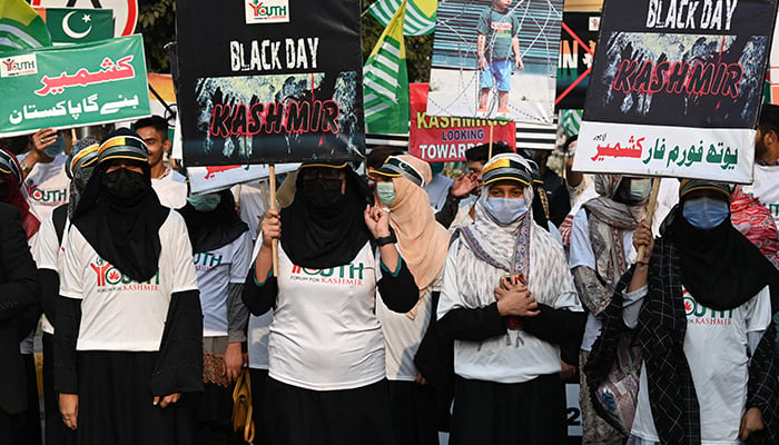 Students hold placards as they march to mark Black Day commemorating the arrival of the Indian army into occupied Jammu and Kashmir in 1947, during a protest in Lahore on October 27, 2022. — AFP