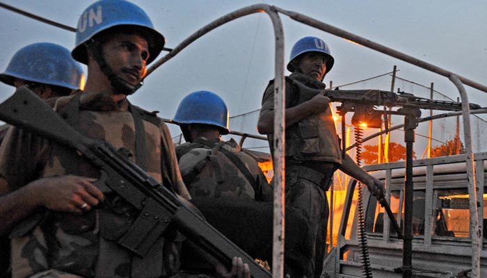 Pakistani UN peacekeepers patrol near the United Nations force in Ivory Coast (ONUCI) headquarters on December 31, 2010, in Abidjan. — AFP/File