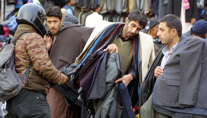 People purchase warm clothes at a roadside stall amid winter season in Pakistan. — APP