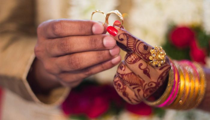 Man and Woman Holding Wedding Rings.— Pexels