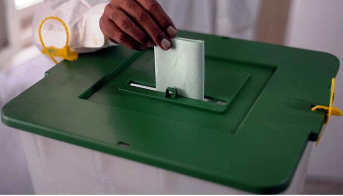 A voter is casting his vote at a polling station during by-elections in the NA-237 constituency in Karachi on October 16, 2022. — PPI