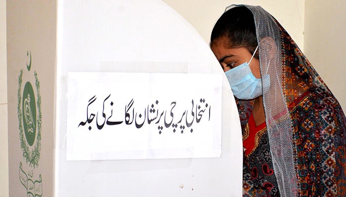 A voter casting her vote at a polling station for the local body election in Hyderabad on January 15, 2023. — INP