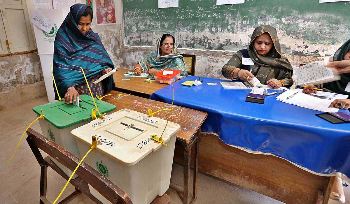 A female voter casts her votes inside the ballot box at a polling station in Hyderabad on January 15, 2023. — APP