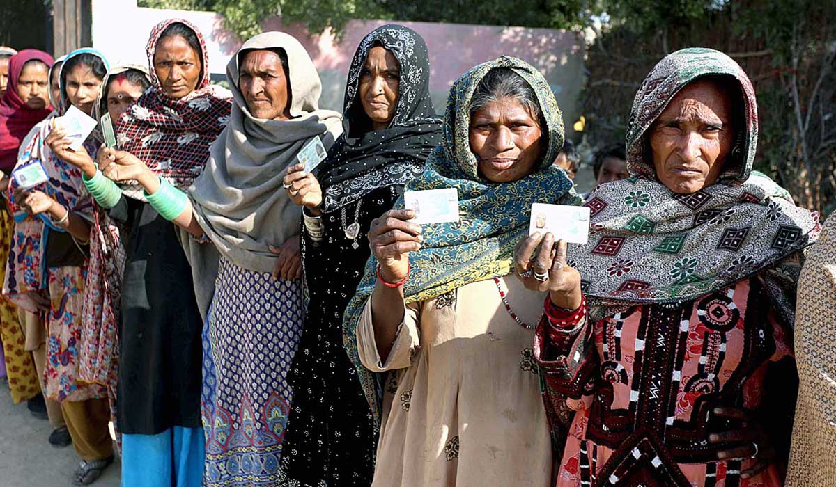 A diverse age group of female voters show their CNICs ahead of casting their votes in phase II of the local body polls in Hyderabad. — APP