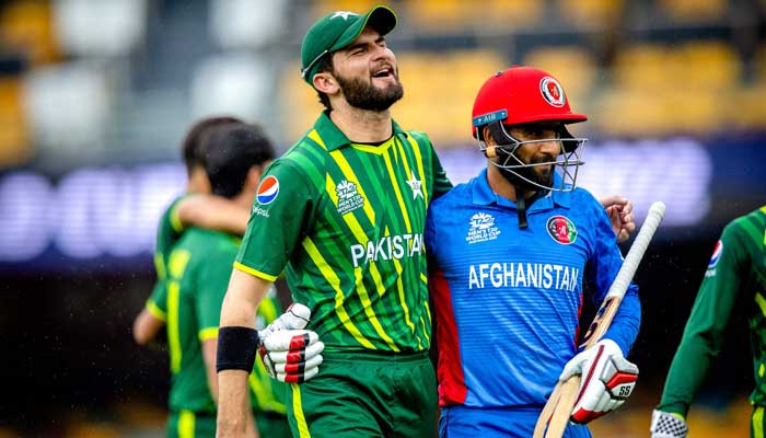 Pakistan pacer Shaheen Shah Afridi (left) embraces Usman Ghani as they both walk off together during the ICC mens T20 World Cup 2022 cricket warm-up match between Afghanistan and Pakistan at the Gabba in Brisbane on October 19, 2022. — AFP