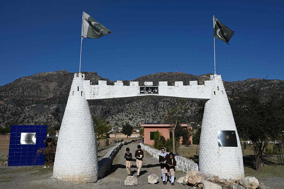 School students walk through the entrance of the Darra Adam Khel Library. — AFP