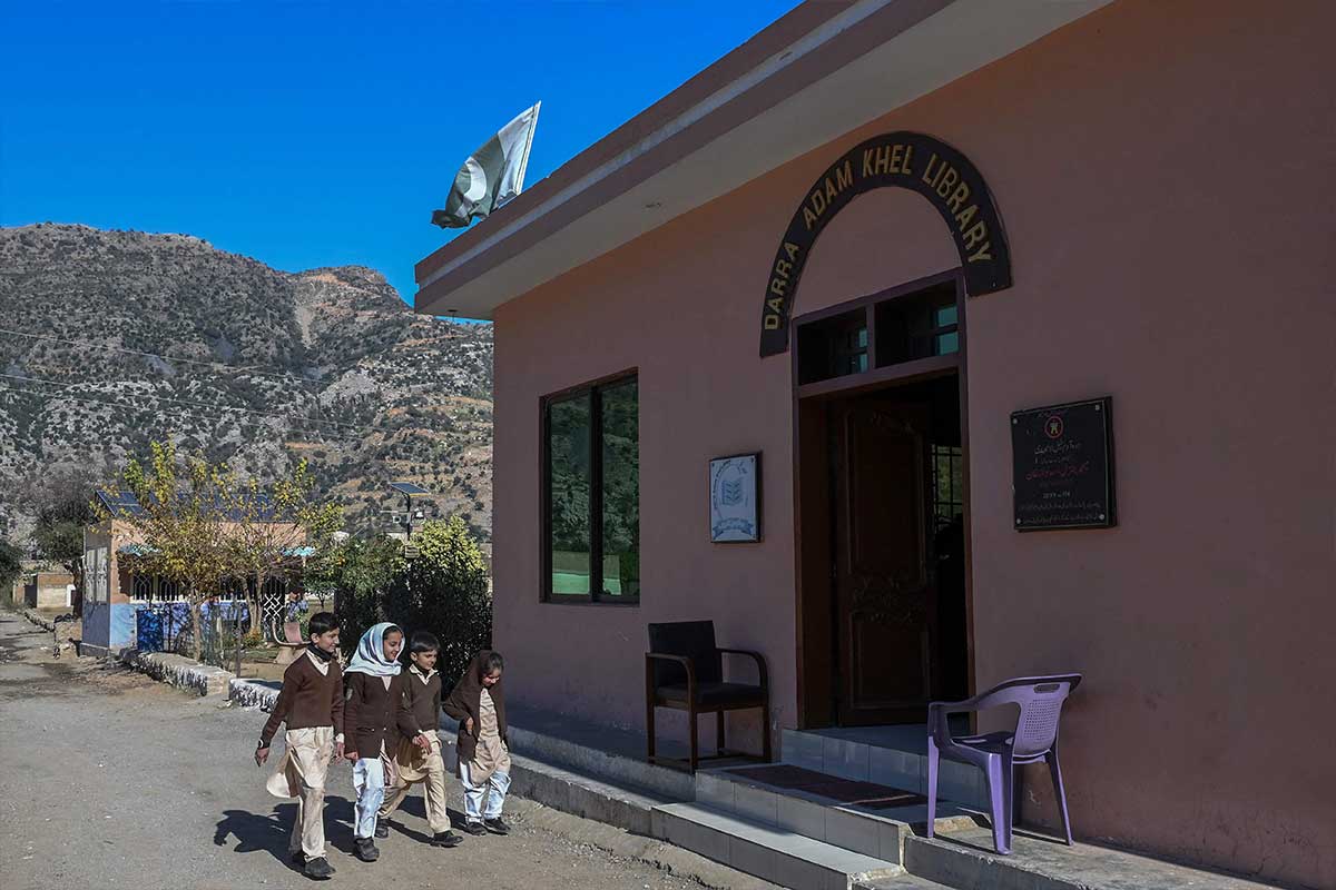 Schoolchildren arrive at the Darra Adam Khel Library. — AFP