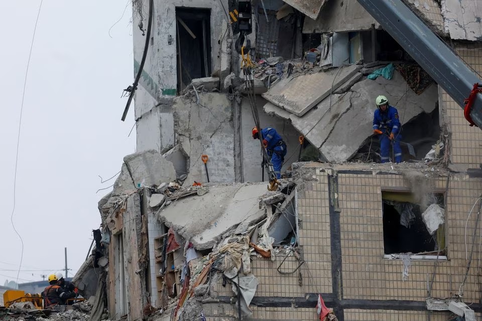 Emergency personnel work at the site where an apartment block was heavily damaged by a Russian missile strike, amid Russias attack on Ukraine, in Dnipro, Ukraine January 16, 2023.— Reuters