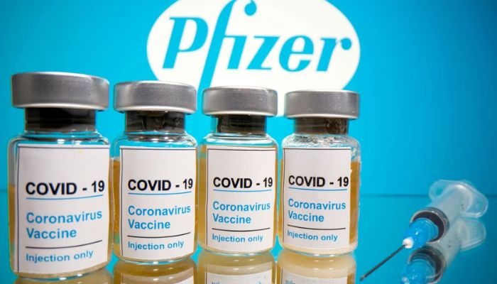 Vials with a sticker reading, COVID-19 / Coronavirus vaccine / Injection only and a medical syringe are seen in front of a displayed Pfizer logo in this illustration taken October 31, 2020.— Reuters