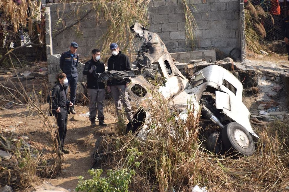 Tim penyelidik Prancis menyelidiki puing-puing pesawat yang dioperasikan Yeti Airlines, di Pokhara, Nepal 18 Januari 2023.— Reuters