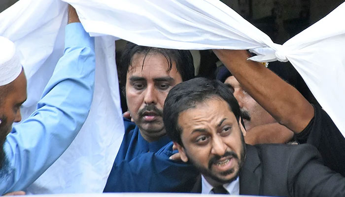 Chief of Staff of former prime minister Imran Khan, Shahbaz Gill, leaves a district court after the hearing in Islamabad, on August 22, 2022. — Online