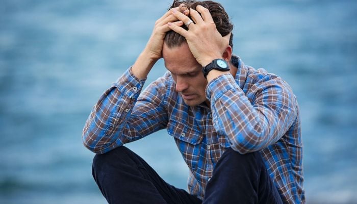 Man in Blue and Brown Plaid Dress Shirt Touching His Hair.— Pexels