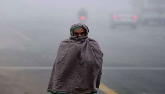 A man wraps himself in a shawl to protect himself from the cold weather. — Reuters/file