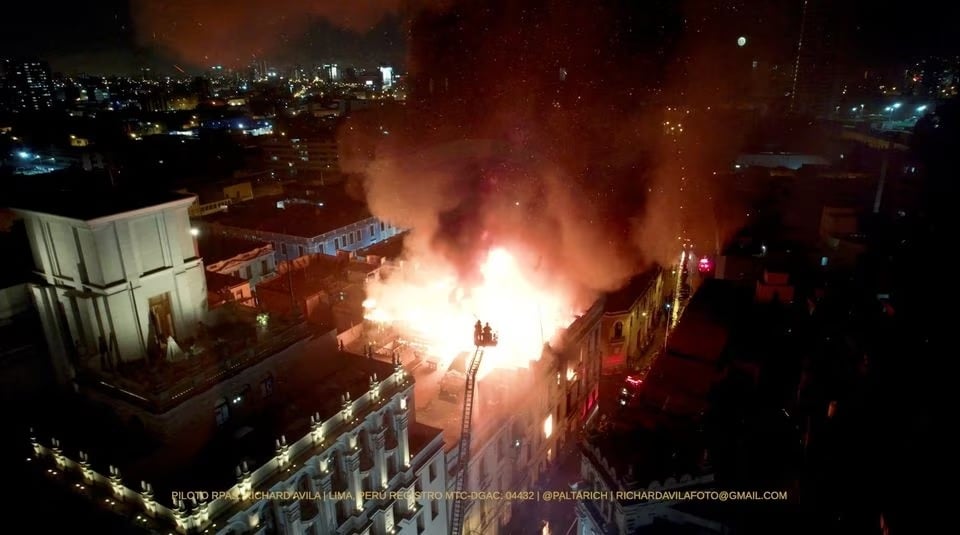 Firefighters work to douse a fire on the top of a building during the Take over Lima march to demonstrate against Perus President Dina Boluarte, following the ousting and arrest of former President Pedro Castillo, in Lima, Peru January 19, 2023, in this screen grab obtained from a social media video.— Twitter/@richaardavila