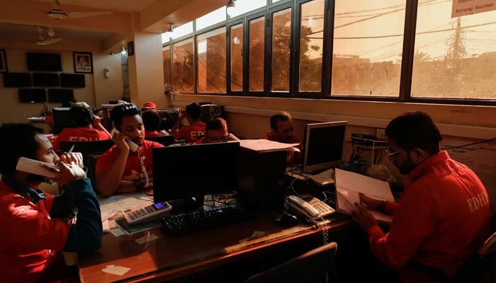 Volunteers of the Edhi Foundation, a non-profit social welfare programme, work at a communication and control room during a country-wide power breakdown in Karachi, Pakistan January 23, 2023. — Reuters