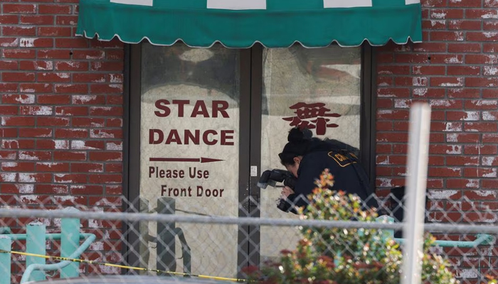A person from the crime lab takes photographs around the rear entrance of the location of a shooting that took place during a Chinese Lunar New Year celebration, in Monterey Park, California, U.S. January 22, 2023. — Reuters