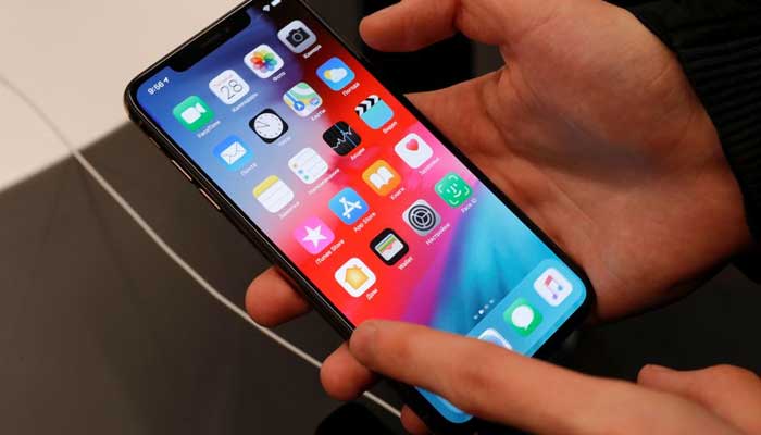 A customer tests a smartphone during the launch of the new iPhone XS and XS Max sales at re:Store Apple reseller shop in Moscow, Russia September 28, 2018. — Reuters