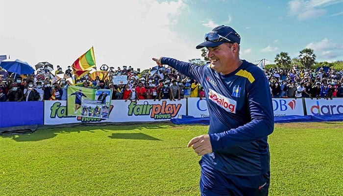 Sri Lankas head coach Mickey Arthur gestures to fans at the end of the second Test cricket match between Sri Lanka and West Indies at the Galle International Cricket Stadium in Galle on December 3, 2021. — AFP