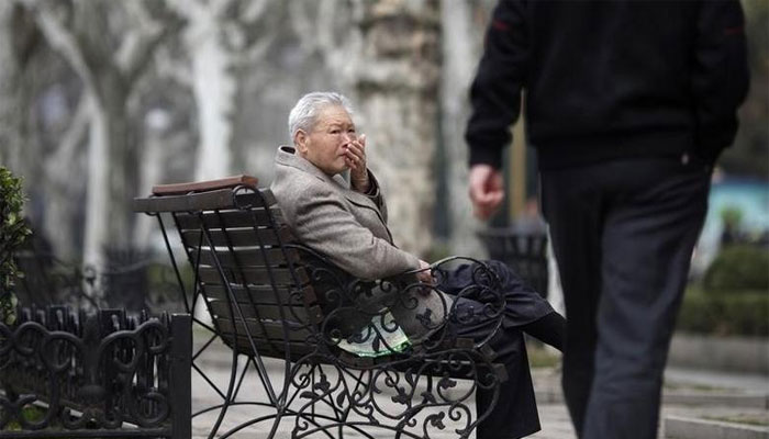 An elderly man sits at a park in Shanghai. — Reuters/File