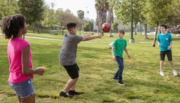 Teenagers Having Fun Playing Soccer Ball on a Park.— Pexels