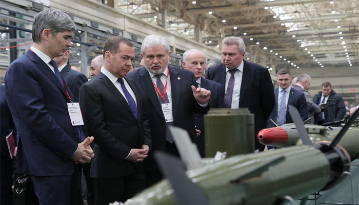 Russia's former leader Dmitry Medvedev (2L), a President Putin ally who is now deputy chairman of the country´s security council, visits the Kalashnikov Group plant in Izhevsk, Russia, on January 24, 2023. — AFP