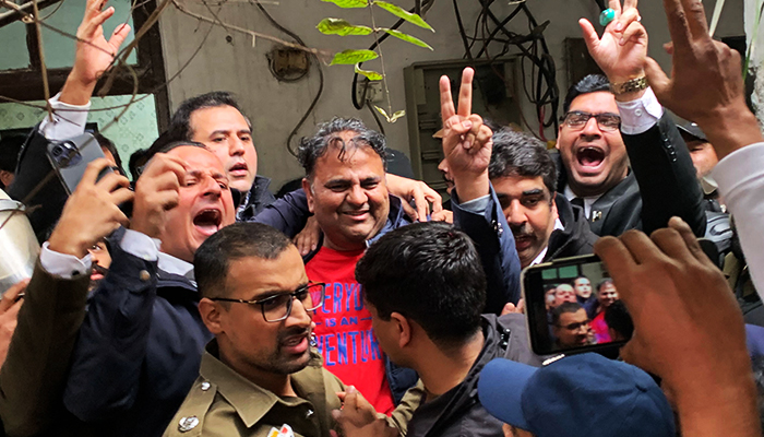 Police officials escort the arrested leader of PTI, Fawad Chaudhry (C) to present him before a court in Lahore on January 25, 2023. — AFP