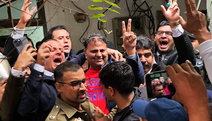 Police officials escort the arrested leader of PTI, Fawad Chaudhry (C) to present him before a court in Lahore on January 25, 2023. — AFP