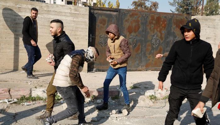 alestinian stone-throwers gather amid clashes with Israeli troops during a raid in Jenin in the Israeli-occupied West Bank January 26, 2023.— Reuters