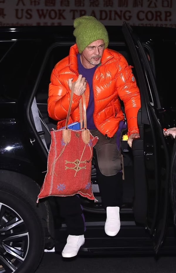 Brad Pitt sports bright orange puffer coat with George Clooney on set of ‘Wolves’