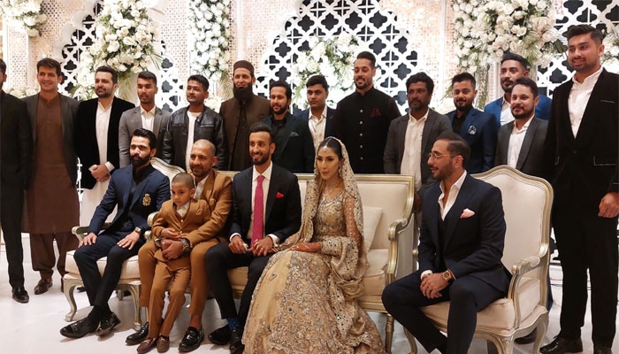Shan Masood (centre) sits on the stage along with his wife Nische Khan (centre right) during his valima ceremony in Karachi on January 27, 2023. — Geo News