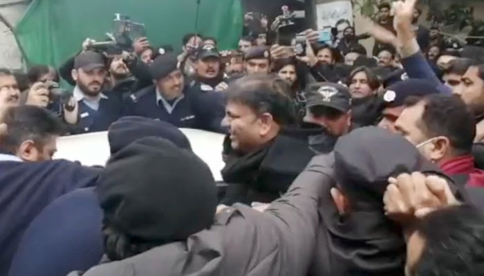 Former information minister and Pakistan Tehreek-e-Insaf leader Fawad Chaudhry being escorted by police officials after a hearing at a court in Islamabad on January 28, 2023. — Geo News screengrab