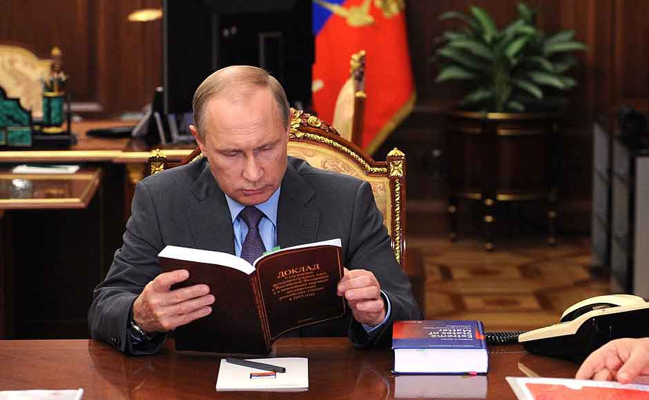 The original image of Russian president Putin, taken in 2016, shows that he was not reading Imran Khan’s autobiography. (Credit Alamy Stock Photo)