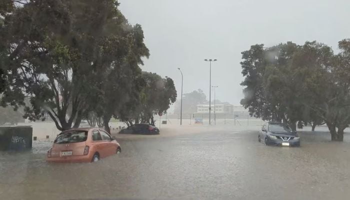 Cars are seen in a flooded street during heavy rainfall in Auckland, New Zealand January 27, 2023, in this screen grab obtained from a social media video. — Reuters