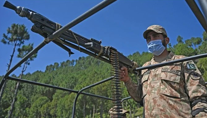 A Pakistani soldier patrols near the Line of Control at Salohi village in Poonch district of Azad Jammu and Kashmir on April 26, 2021. — AFP