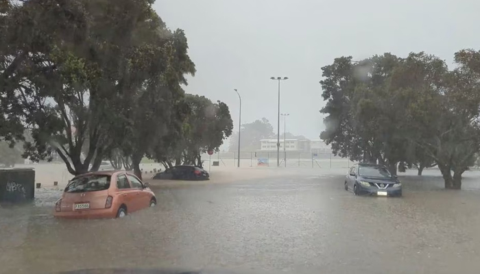 Cars are seen in a flooded street during heavy rainfall in Auckland, New Zealand January 27, 2023, in this screen grab obtained from a social media video. — Reuters