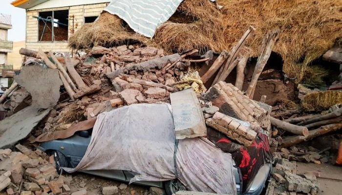 A damaged car is seen under the ruins, after an earthquake hit the Varankesh village in Eastern Azerbaijan province, northwest of Tehran, Iran November 08, 2019.— Reuters