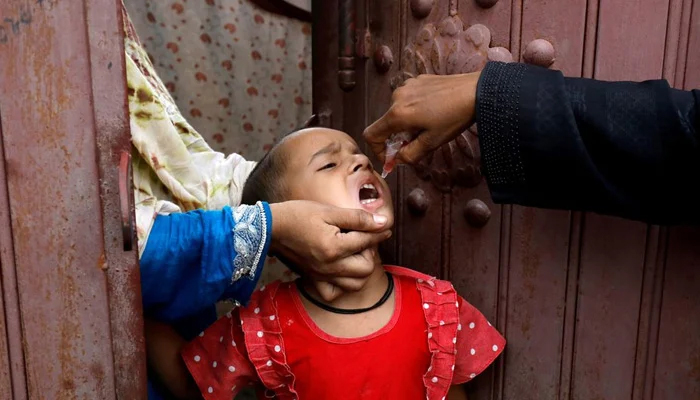A girl receives polio vaccine drops, during an anti-polio campaign, in a low-income neighborhood as the spread of the coronavirus disease (COVID-19) continues, in Karachi, Pakistan July 20, 2020. — Reuters