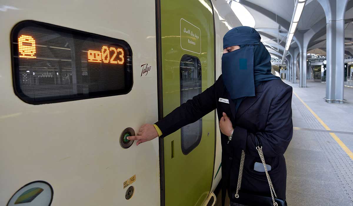 Tharaa Ali opens the door of the high-speed train. — AFP