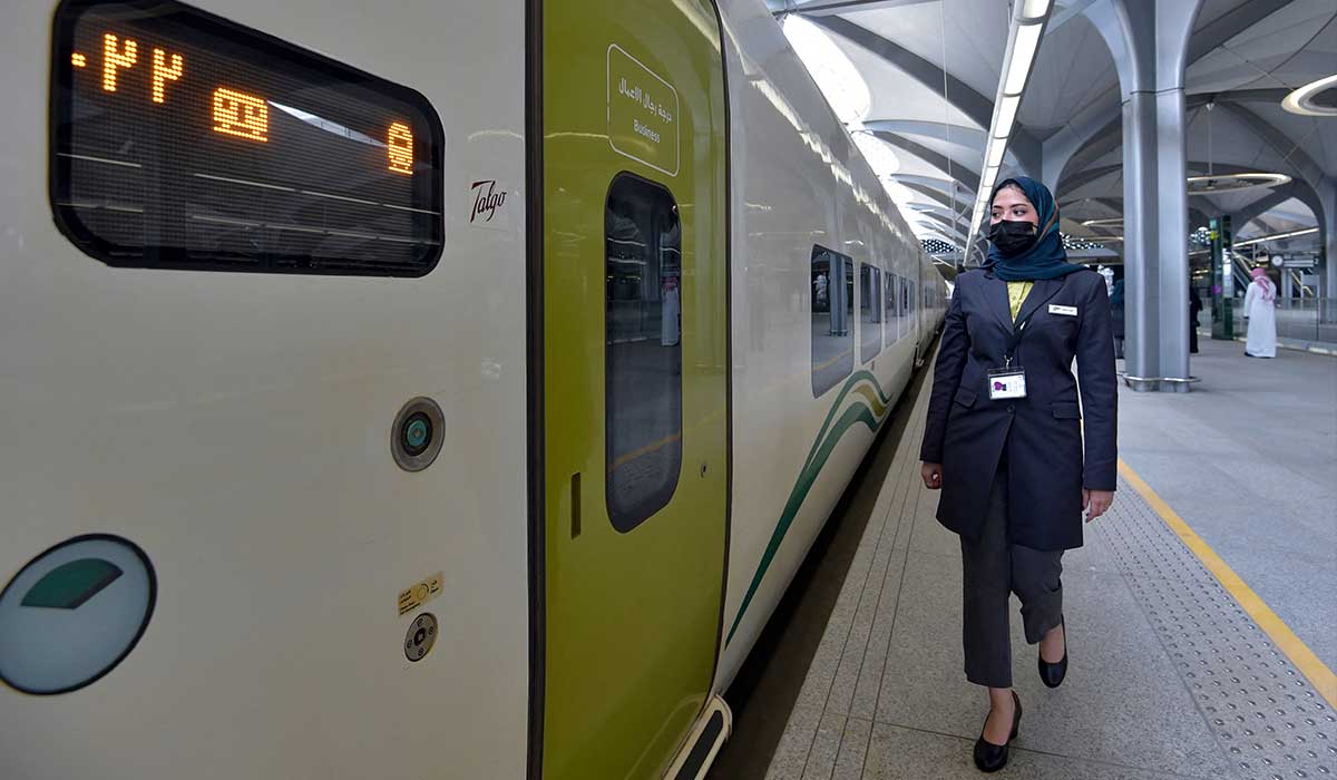 A Saudi conductor walks beside the high-speed train. — AFP